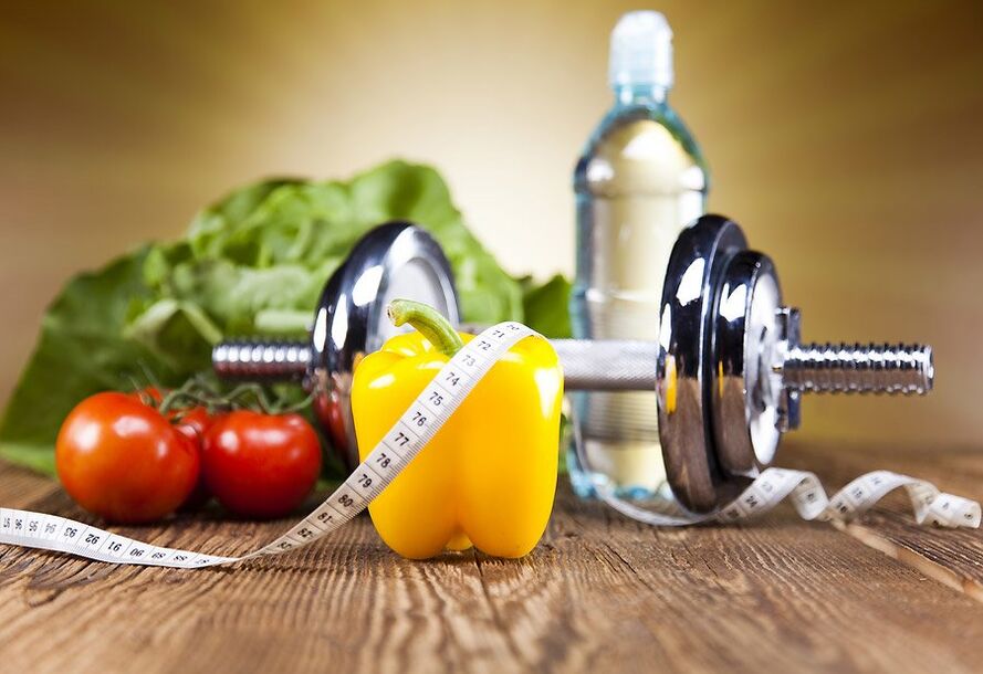 Dumbbell, groenten en centimeter tape